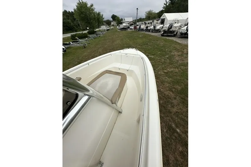 Slide: The Image of 2012 Scout 210 XSF boat on grassy area, surrounded by other boats. - 19