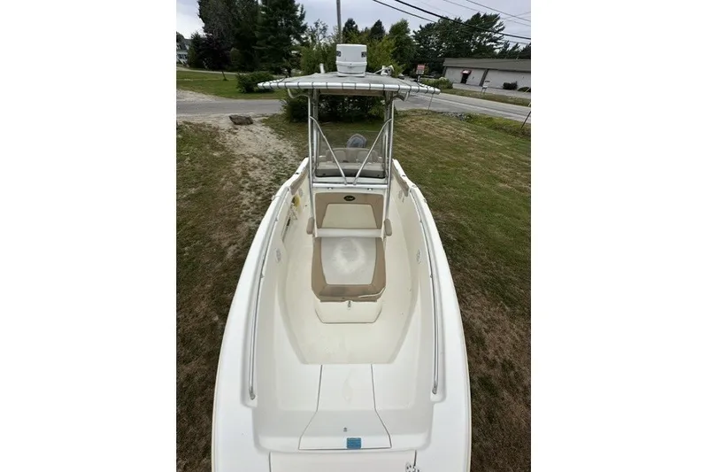 Slide: The Image of 2012 Scout 210 XSF boat with T-top, viewed from above on grassy area. - 8