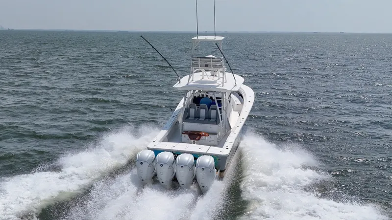 Slide: The Image of A 2019 Regulator 41 FS speeds across the sea, powered by four outboard engines. - 2