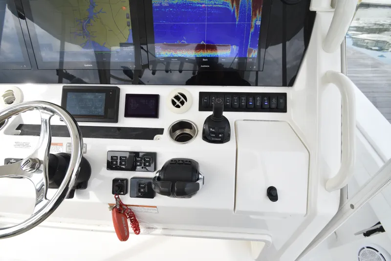 Slide: The Image of The image shows the helm of a 2019 Regulator 41 FS with modern navigation systems. - 27