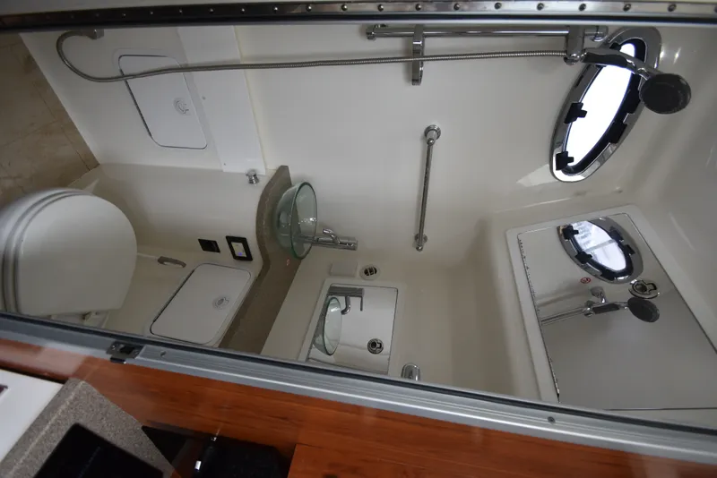 Slide: The Image of The image shows the bathroom of a 2019 Regulator 41 FS with a sink, toilet, and shower. - 39
