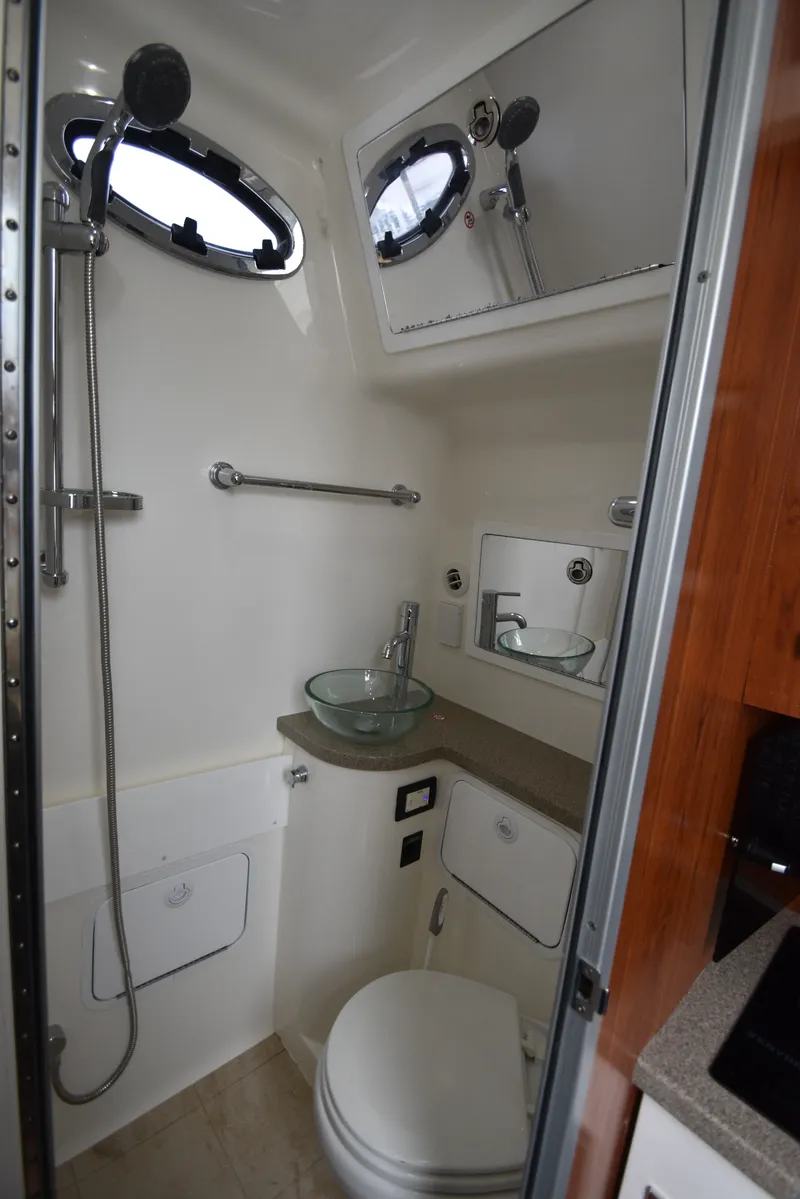 Slide: The Image of Bathroom with glass sink, toilet, and shower in a boat. - 37