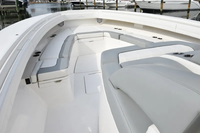 Slide: The Image of The image shows the spacious bow area of a 2019 Regulator 41 FS with gray upholstery. - 32