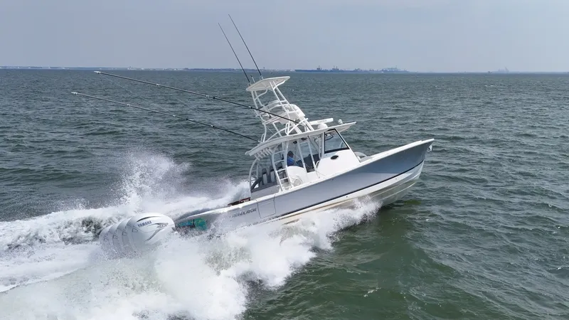 Slide: The Image of A 2019 Regulator 41 FS speeds across the sea, equipped with multiple fishing rods. - 4