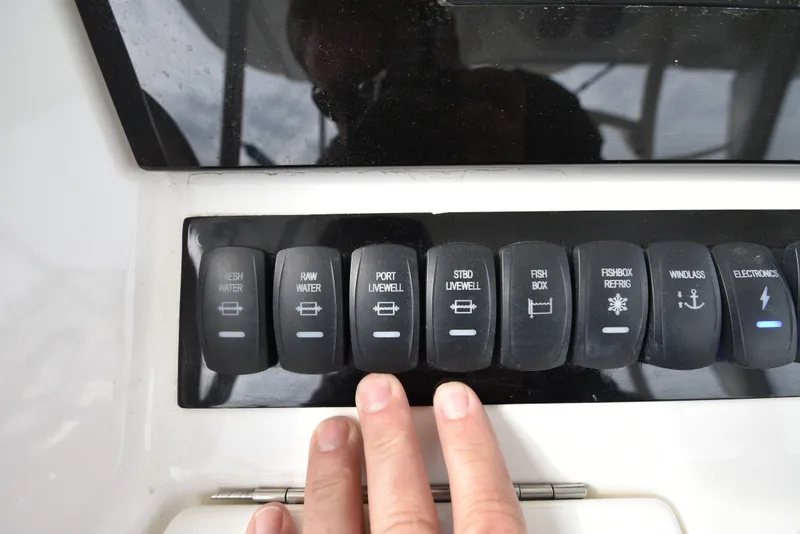 Slide: The Image of A control panel with various switches for functions like fresh water, bilge pumps, and electronics. - 25