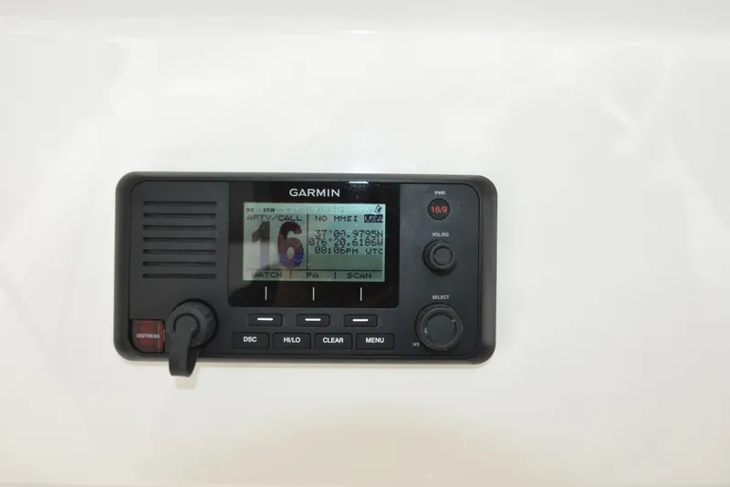Slide: The Image of A Garmin radio is mounted on the white wall of a boat. - 30