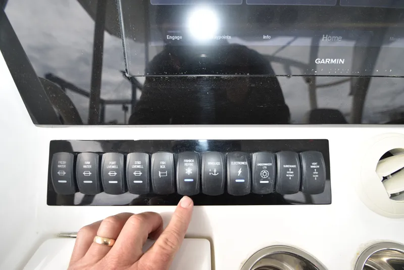 Slide: The Image of Close-up of a control panel with various switches and a Garmin screen. - 24