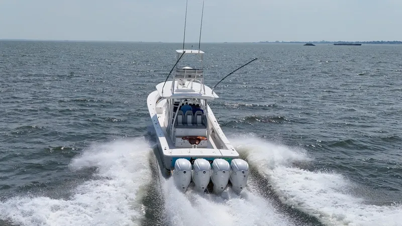 Slide: The Image of A 2019 Regulator 41 FS boat speeds across the water, powered by four outboard engines. - 3