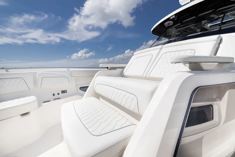 Slide: The Image of Luxurious seating on the 2027 Pursuit S 388 Sport boat under a clear blue sky. - 9