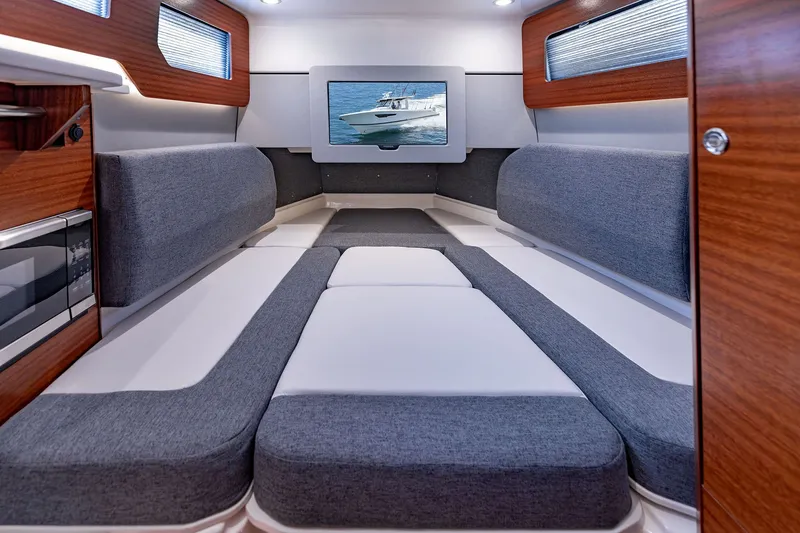 Slide: The Image of Luxurious interior of 2027 Pursuit S 388 Sport boat with modern seating and wood accents. - 32
