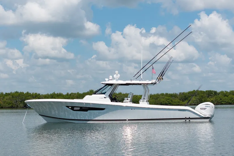 The Image of 2027 Pursuit S 388 Sport boat on calm water under a cloudy sky. - 1