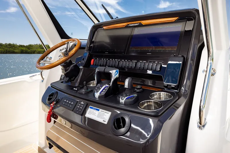 Slide: The Image of Helm of 2027 Pursuit S 388 Sport boat with advanced controls and navigation displays. - 11