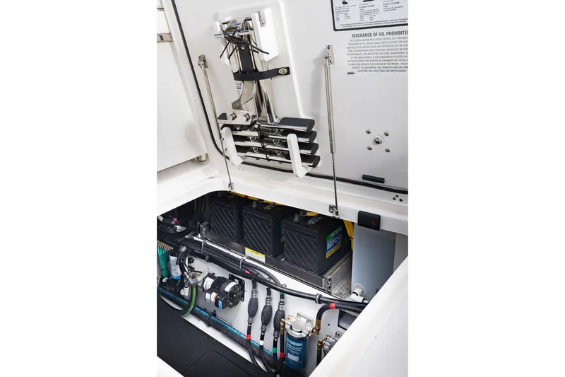 Slide: The Image of 2027 Pursuit S 388 Sport boat engine compartment with batteries and wiring. - 26