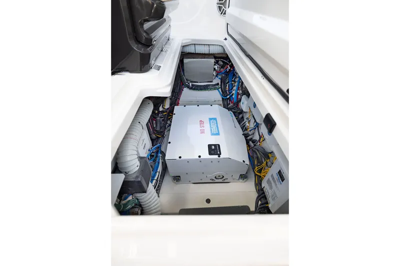 Slide: The Image of Engine compartment of 2027 Pursuit S 388 Sport boat, showcasing wiring and components. - 25