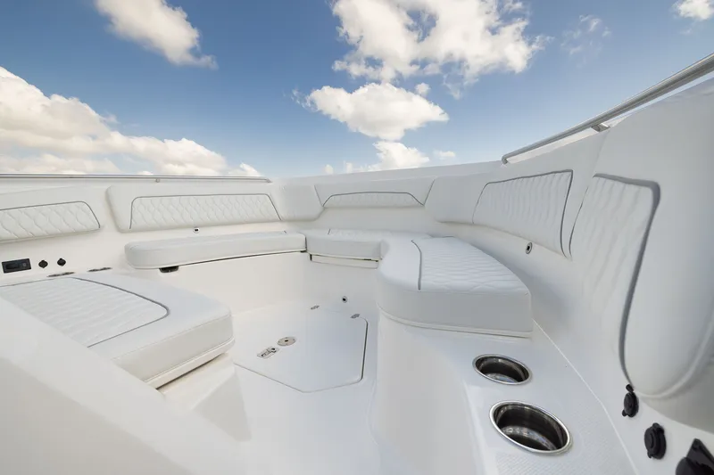 Slide: The Image of Luxurious seating area on 2027 Pursuit S 388 Sport boat under a clear blue sky. - 6
