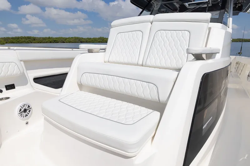 Slide: The Image of Luxurious seating on 2027 Pursuit S 388 Sport boat with white upholstery and scenic background. - 8