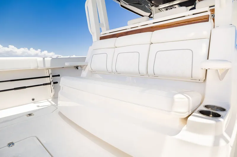Slide: The Image of 2027 Pursuit S 388 Sport boat interior with white seating and cup holders. - 19