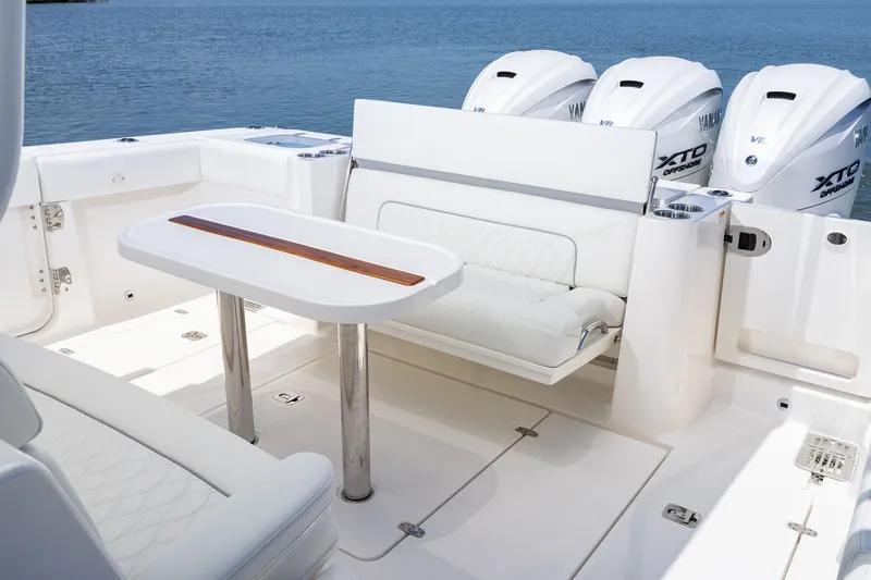 Slide: The Image of Luxurious seating area on 2027 Pursuit S 388 Sport boat with triple Yamaha engines. - 22