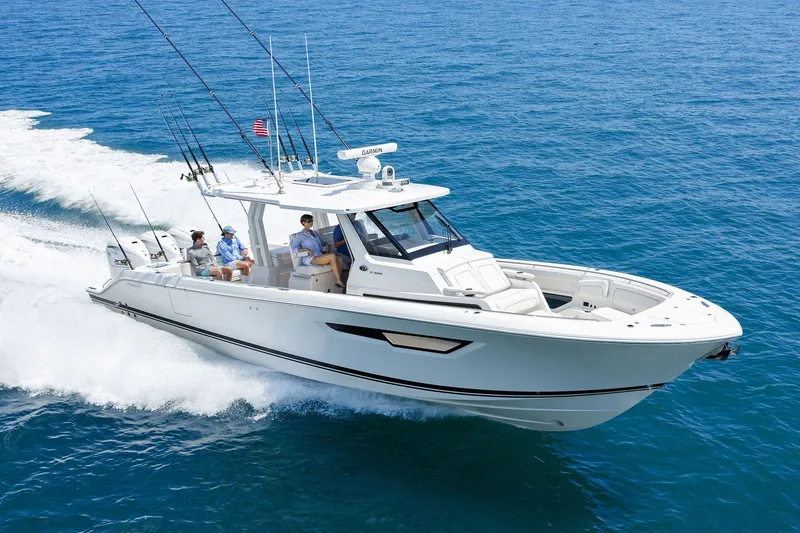Slide: The Image of 2027 Pursuit S 388 Sport boat cruising on open ocean with passengers onboard. - 0