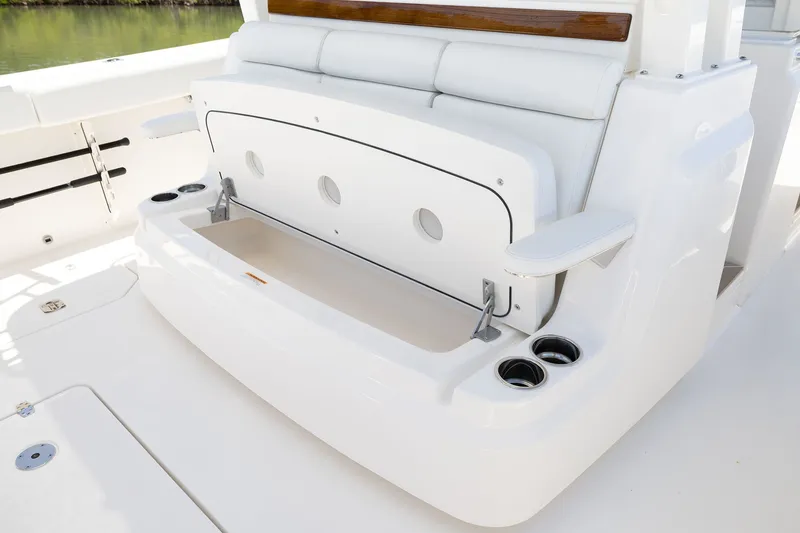 Slide: The Image of 2027 Pursuit S 388 Sport boat seating area with storage and cup holders. - 20