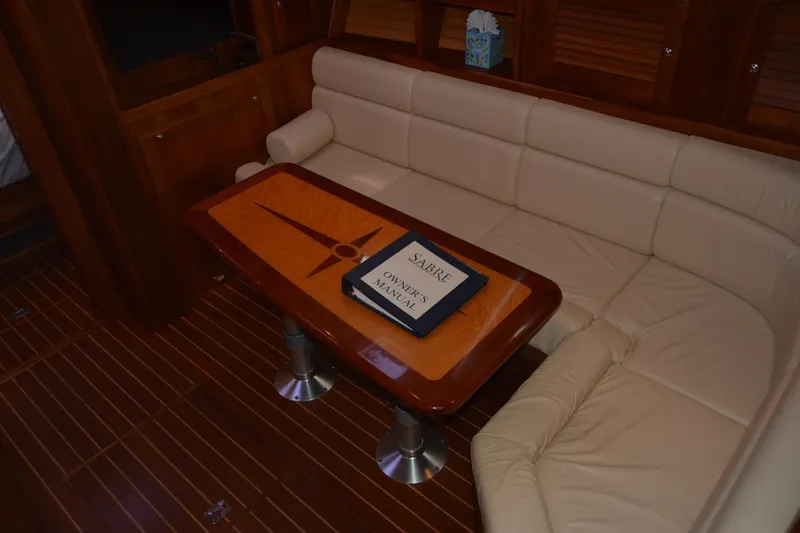 Slide: The Image of Luxurious interior of 2005 Sabre 38 Express yacht with elegant wood table and plush seating. - 61