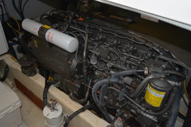 Slide: The Image of Engine compartment of a 2005 Sabre 38 Express boat, featuring a Yanmar engine. - 99