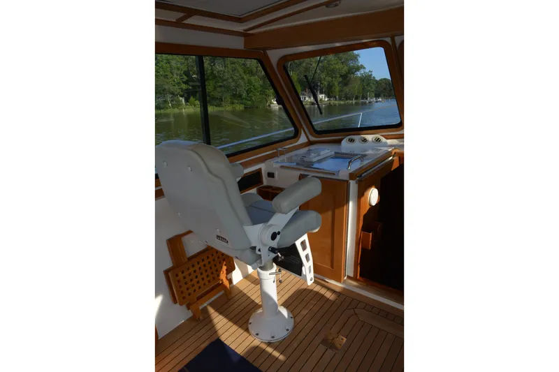 Slide: The Image of Interior helm of 2005 Sabre 38 Express boat with captain's chair and scenic river view. - 37