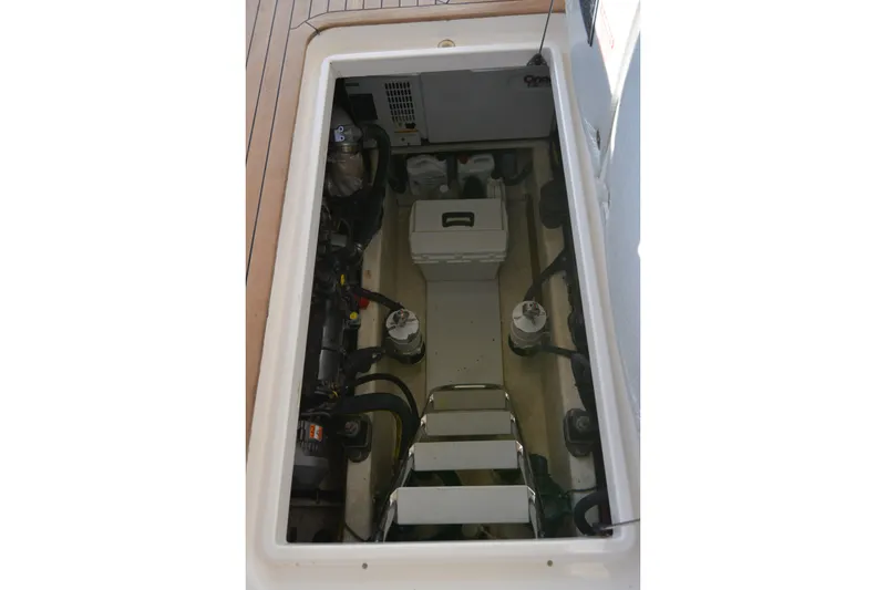 Slide: The Image of Engine compartment of 2005 Sabre 38 Express boat, showcasing mechanical components and storage. - 95