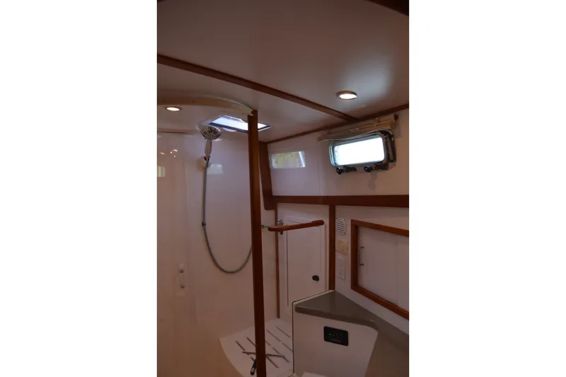 Slide: The Image of Interior of 2005 Sabre 38 Express yacht bathroom with shower and porthole window. - 87