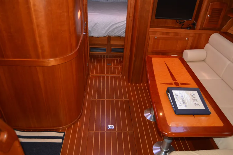 Slide: The Image of Luxurious interior of 2005 Sabre 38 Express yacht with wooden finishes and seating area. - 60