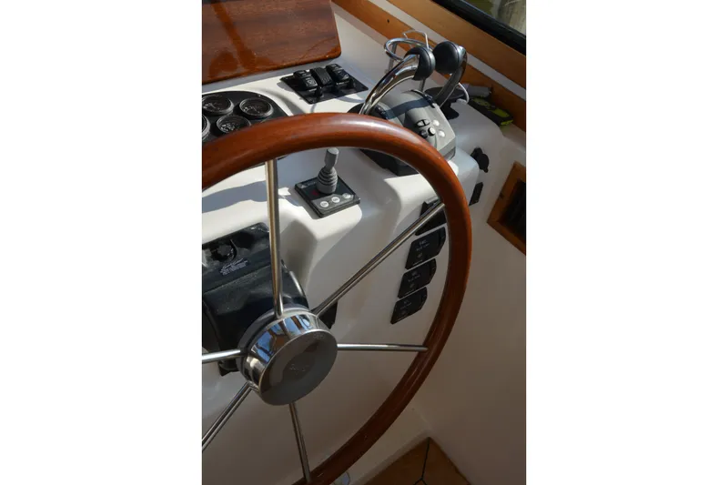Slide: The Image of Steering wheel and controls of a 2005 Sabre 38 Express boat cockpit. - 46