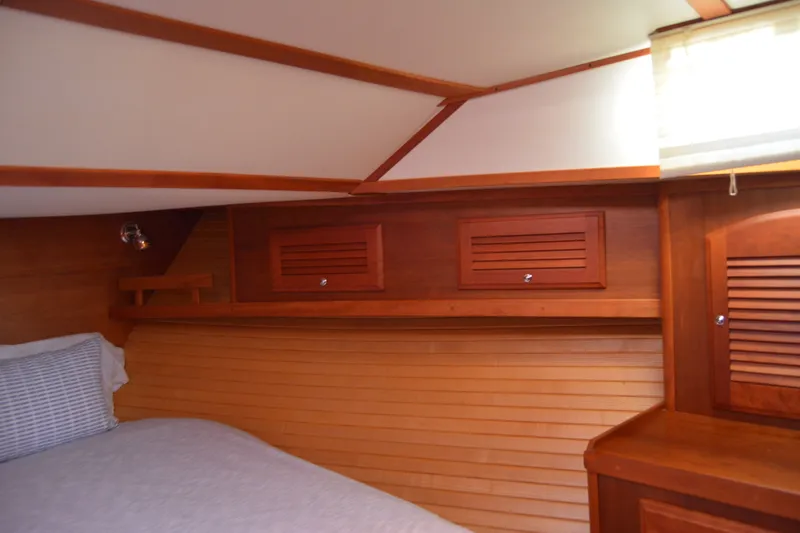 Slide: The Image of Interior cabin of 2005 Sabre 38 Express yacht with wooden cabinetry and bed. - 84