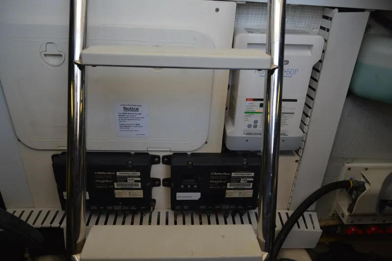 Slide: The Image of Engine room of 2005 Sabre 38 Express with control units and ladder. - 102