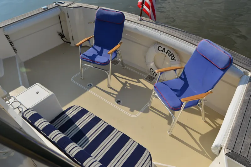 Slide: The Image of Deck of 2005 Sabre 38 Express with blue chairs and striped seating. - 19