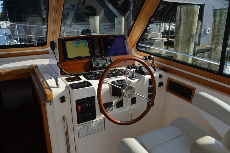 Slide: The Image of 2005 Sabre 38 Express helm with navigation screens and wooden steering wheel. - 39