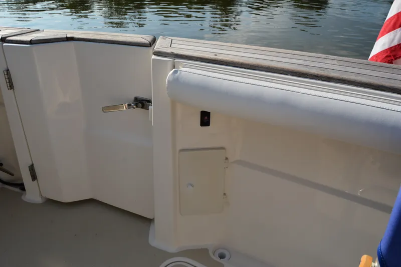 Slide: The Image of 2005 Sabre 38 Express boat deck with wooden railing and water view. - 28