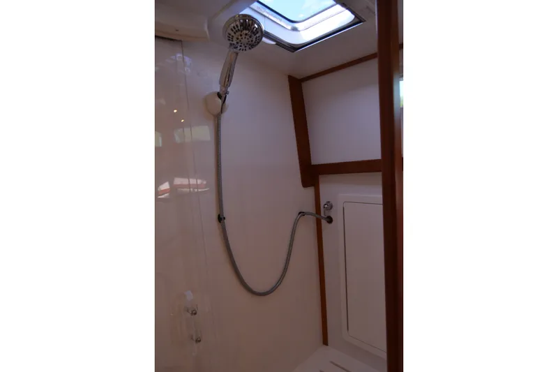 Slide: The Image of Shower area in 2005 Sabre 38 Express yacht with skylight and wooden accents. - 90