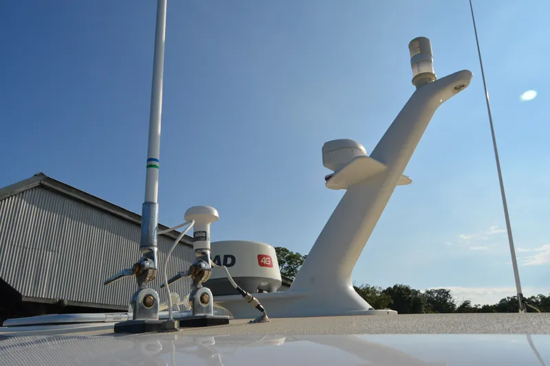 Slide: The Image of Antenna and radar equipment on 2005 Sabre 38 Express boat under clear blue sky. - 13
