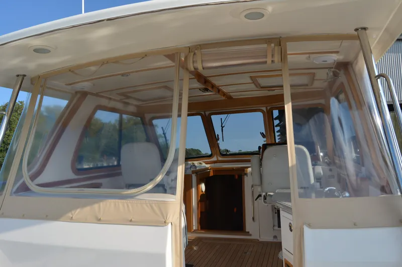 Slide: The Image of 2005 Sabre 38 Express boat interior with clear enclosure and seating. - 24