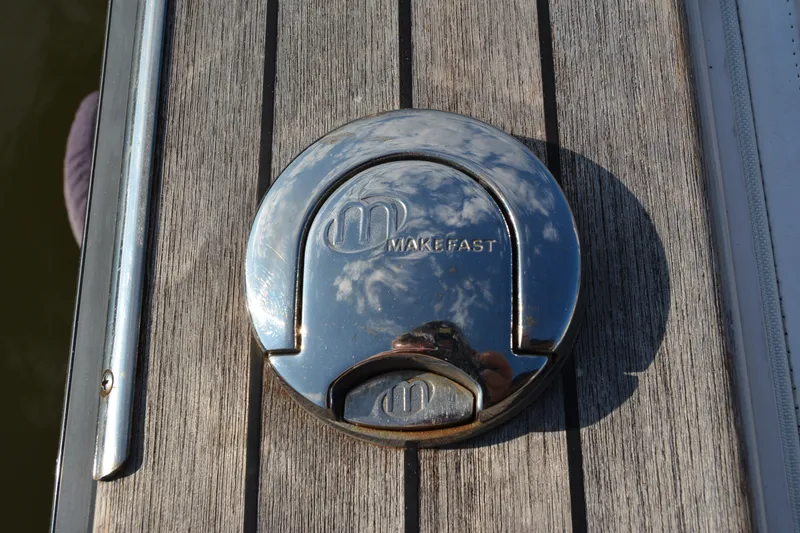 Slide: The Image of Chrome deck fitting on 2005 Sabre 38 Express yacht, reflecting sky and clouds. - 31
