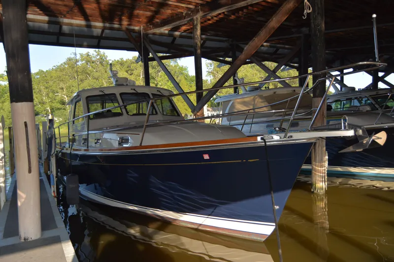 Slide: The Image of 2005 Sabre 38 Express yacht docked in a covered marina. - 115