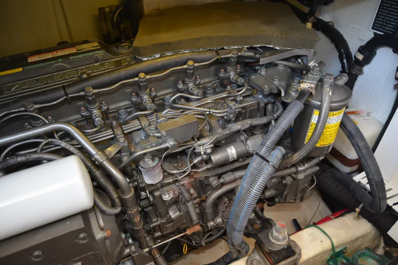 Slide: The Image of Engine compartment of a 2005 Sabre 38 Express boat, showcasing detailed mechanical components. - 103