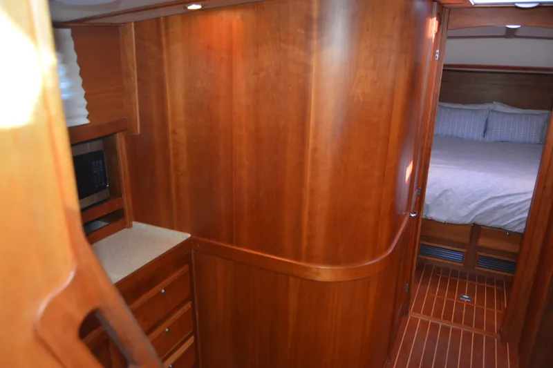 Slide: The Image of Interior of 2005 Sabre 38 Express yacht with wood paneling and cozy bedroom. - 62