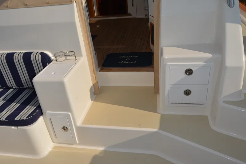 Slide: The Image of Interior of 2005 Sabre 38 Express yacht with striped seating and storage drawers. - 26