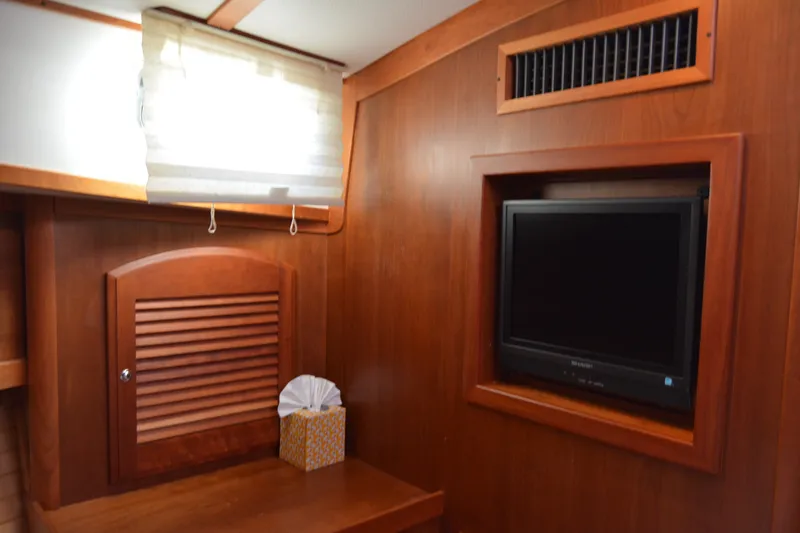 Slide: The Image of Interior of 2005 Sabre 38 Express yacht with wood paneling and built-in TV. - 85