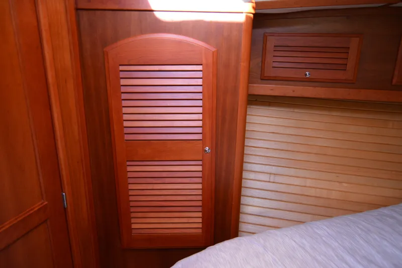 Slide: The Image of Interior of 2005 Sabre 38 Express yacht with wooden cabinetry and louvered doors. - 86