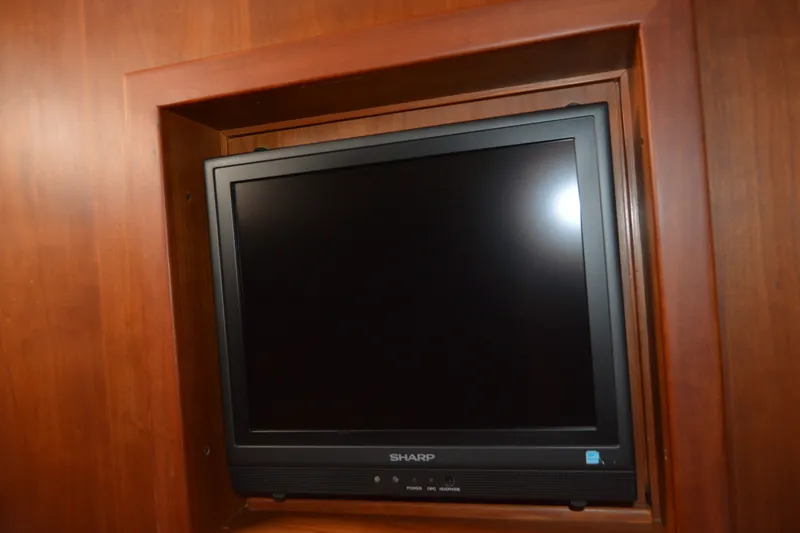 Slide: The Image of Sharp TV mounted in wooden cabinet on 2005 Sabre 38 Express boat. - 91