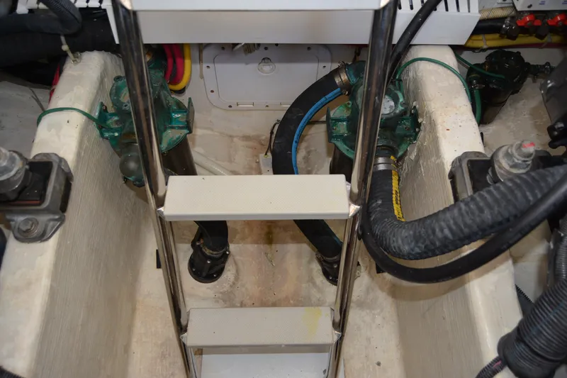 Slide: The Image of Engine compartment of a 2005 Sabre 38 Express boat with visible components and ladder. - 110