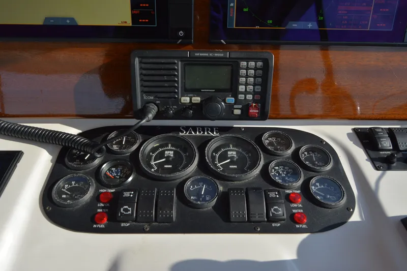 Slide: The Image of Control panel of a 2005 Sabre 38 Express boat with gauges and radio equipment. - 40