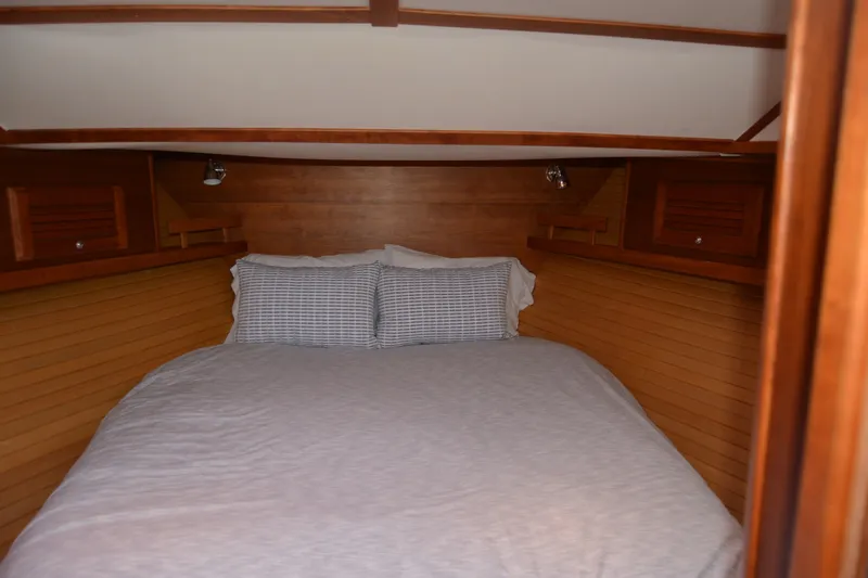 Slide: The Image of Cozy cabin interior of 2005 Sabre 38 Express yacht with wooden paneling and bed. - 82